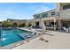 Enjoy the luxury backyard featuring a sparkling pool, sun loungers, and an outdoor living area for entertaining at 4208 Lapis Ridge Ct, Las Vegas, NV 89135