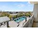 Stunning view of the pool and spa from the balcony, with well-manicured landscaping at 4208 Lapis Ridge Ct, Las Vegas, NV 89135