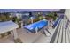 Backyard showcases a modern pool and spa, lounge chairs, and outdoor kitchen under the covered patio at 4208 Lapis Ridge Ct, Las Vegas, NV 89135