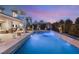 A picturesque pool and spa illuminated at dusk, with lush greenery and modern design at 4208 Lapis Ridge Ct, Las Vegas, NV 89135