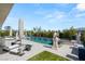 A spacious patio surrounding a pool with statues, lounge chairs and lush landscaping at 4208 Lapis Ridge Ct, Las Vegas, NV 89135
