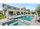A stunning pool and backyard featuring an outdoor living space and pristine landscaping at 4208 Lapis Ridge Ct, Las Vegas, NV 89135