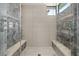 Walk-in shower with dual shower heads, built-in seating, and designer tile at 4208 Lapis Ridge Ct, Las Vegas, NV 89135
