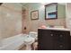 Full bathroom featuring a shower-tub combo and neutral earth-tone tiling at 4343 Sharpshooter Ln, North Las Vegas, NV 89031