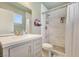 Bright bathroom featuring a walk-in shower with stylish gray and white tiling at 4343 Sharpshooter Ln, North Las Vegas, NV 89031