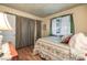 Bedroom with hardwood floors, a four-poster bed, and bright natural lighting at 4343 Sharpshooter Ln, North Las Vegas, NV 89031