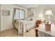 Bedroom with hardwood floors, a four-poster bed, and bright natural lighting at 4343 Sharpshooter Ln, North Las Vegas, NV 89031