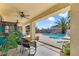 Covered patio with ceiling fans overlooking a backyard pool, creating an inviting outdoor living and entertaining space at 4343 Sharpshooter Ln, North Las Vegas, NV 89031