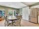 Dining area with an adjacent stainless steel refrigerator, and a sliding glass door at 4343 Sharpshooter Ln, North Las Vegas, NV 89031