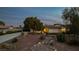 Charming single-story home with desert landscaping, mature trees and a welcoming facade at 4343 Sharpshooter Ln, North Las Vegas, NV 89031