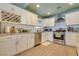 Updated kitchen featuring white cabinets, stainless steel appliances, and bright lighting for a modern feel at 4343 Sharpshooter Ln, North Las Vegas, NV 89031