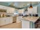 Modern kitchen with white cabinets, stainless steel appliances, granite countertops, and a stylish wine rack at 4343 Sharpshooter Ln, North Las Vegas, NV 89031