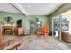 Cozy living room with a fireplace, stylish decor, and natural light at 4343 Sharpshooter Ln, North Las Vegas, NV 89031