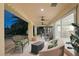 Relaxing covered patio with stylish seating, ceiling fans, and sliding glass doors to the interior at 4343 Sharpshooter Ln, North Las Vegas, NV 89031