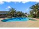 Inviting pool area with jacuzzi, surrounded by palm trees, offers a perfect backyard retreat for relaxation and entertainment at 4343 Sharpshooter Ln, North Las Vegas, NV 89031