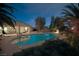 Backyard features a large, inviting pool, lush greenery, and ample space for outdoor entertaining at 4343 Sharpshooter Ln, North Las Vegas, NV 89031