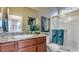 Bathroom features granite countertops, a glass-enclosed shower, and a large mirror with decorative accents at 4420 Stardusk Falls Ave, North Las Vegas, NV 89084
