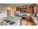 Modern kitchen with stainless steel appliances, granite countertops, and seating at the island at 4420 Stardusk Falls Ave, North Las Vegas, NV 89084
