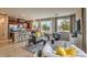 Open concept living room featuring a modern kitchen, comfortable seating, and large windows for natural light at 4420 Stardusk Falls Ave, North Las Vegas, NV 89084