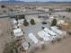 An aerial view of a mobile home park featuring well-maintained lots, mature trees, and gravel driveway at 4861 Pahrump Valley Blvd, Pahrump, NV 89048