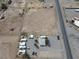 Aerial view of a mobile home park with a vacant lot, storage units, and mountains in the distance at 4861 Pahrump Valley Blvd, Pahrump, NV 89048