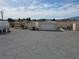 Wide-open backyard with a shed, storage container, and garage, offering ample space and versatile storage solutions at 4861 Pahrump Valley Blvd, Pahrump, NV 89048