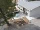 Aerial view of a backyard featuring an outdoor kitchen, ample seating, a firepit, and desert landscaping at 4861 Pahrump Valley Blvd, Pahrump, NV 89048