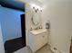 Classic half bathroom with white vanity, oval mirror, and stylish lighting creating a tidy and welcoming space at 4861 Pahrump Valley Blvd, Pahrump, NV 89048