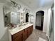 Bright bathroom featuring a dual vanity, mirrors, and a jacuzzi style tub at 4861 Pahrump Valley Blvd, Pahrump, NV 89048