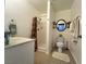 Bright bathroom with a shower, toilet, and single sink vanity, offering a clean and functional space at 4861 Pahrump Valley Blvd, Pahrump, NV 89048