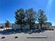 Charming single story home with desert landscaping, mature trees, and long driveway on a sunny day at 4861 Pahrump Valley Blvd, Pahrump, NV 89048