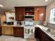 Bright kitchen featuring wood cabinetry, tile countertops, and modern appliances at 4861 Pahrump Valley Blvd, Pahrump, NV 89048
