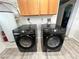 Modern laundry setup with black front-load washer and dryer, alongside a white water heater, for efficient laundry at 4861 Pahrump Valley Blvd, Pahrump, NV 89048