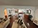 Bright, open concept living room featuring hardwood floors, modern furnishings, and a view of the dining room at 4861 Pahrump Valley Blvd, Pahrump, NV 89048