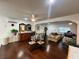 Open-concept living room with a bar, dining table, hardwood flooring, and ample natural light at 4861 Pahrump Valley Blvd, Pahrump, NV 89048