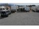 Spacious yard featuring RVs and a jeep, providing ample parking and showcasing the property's versatility at 4861 Pahrump Valley Blvd, Pahrump, NV 89048