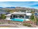 Stunning aerial view highlighting the property's pool, spa, and mountain views at 49 Crested Cloud Way, Las Vegas, NV 89135