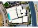Aerial view of modern home with pool, manicured landscaping, and unique roof lines at 49 Crested Cloud Way, Las Vegas, NV 89135