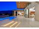Elegant backyard featuring a swimming pool, outdoor kitchen, and seamless indoor-outdoor living at 49 Crested Cloud Way, Las Vegas, NV 89135