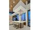 Contemporary bar area with unique lighting, modern fixtures, and comfortable seating by large windows at 49 Crested Cloud Way, Las Vegas, NV 89135