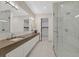 A sleek and modern bathroom with double sinks, and a glass enclosed shower at 49 Crested Cloud Way, Las Vegas, NV 89135