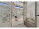 This spacious bathroom has a soaking tub, a shower and a makeup vanity at 49 Crested Cloud Way, Las Vegas, NV 89135