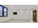 Bright and airy bedroom with wall mounted television and a sliding door to the bathroom at 49 Crested Cloud Way, Las Vegas, NV 89135
