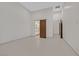 Bedroom with a sliding barn door to the bathroom and bright white tile at 49 Crested Cloud Way, Las Vegas, NV 89135