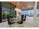 Open concept dining area with modern chandelier, and backyard views at 49 Crested Cloud Way, Las Vegas, NV 89135
