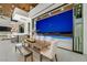 Open-concept dining area with access to an outdoor pool and stunning views through sliding glass doors at 49 Crested Cloud Way, Las Vegas, NV 89135