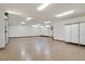 Spacious garage with epoxy flooring, built-in storage, and modern lighting at 49 Crested Cloud Way, Las Vegas, NV 89135