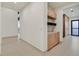 Bright hallway featuring tiled floors and built-in cabinets for efficient storage solutions at 49 Crested Cloud Way, Las Vegas, NV 89135