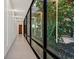 Bright hallway with large windows looking into a rock garden at 49 Crested Cloud Way, Las Vegas, NV 89135