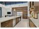 Gourmet kitchen featuring a large island, stainless steel appliances, and custom wood cabinetry at 49 Crested Cloud Way, Las Vegas, NV 89135